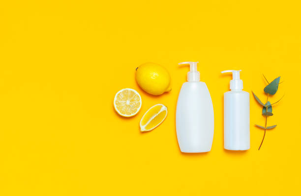 istock Whites Cosmetic bottle containers fresh lemon orange eucalyptus on yellow background top view flat lay copy space. Blank label for branding mock-up Natural beauty product concept Shower Gel Soap Cream 1386722891