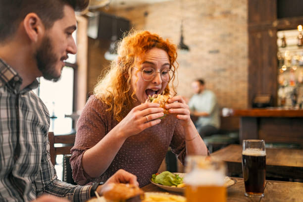 istock Young couple having meal in the restaurant 1386728548