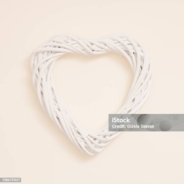A Heart Made Of Knitted White Wicker On A Pastel Beige Background Minimal Creative Concept Of Decorative Infatuation Love Valentines Day Weddings Stock Photo - Download Image Now