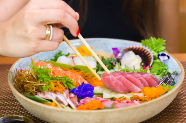 istock Woman eating delicious sushi 1386732343