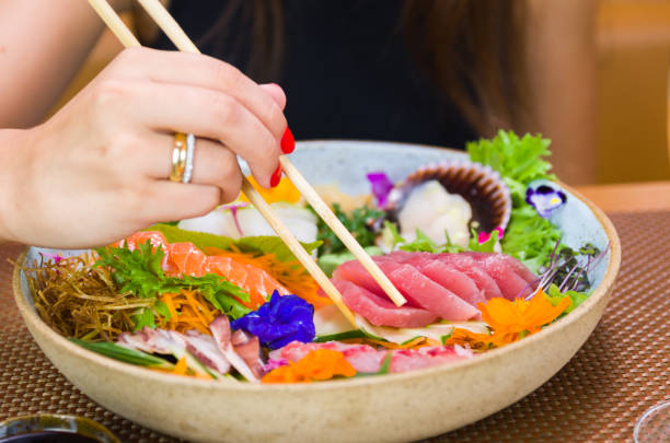 istock Woman eating delicious sushi 1386732402