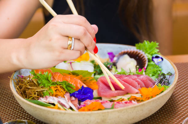 istock Woman eating delicious sushi 1386732403