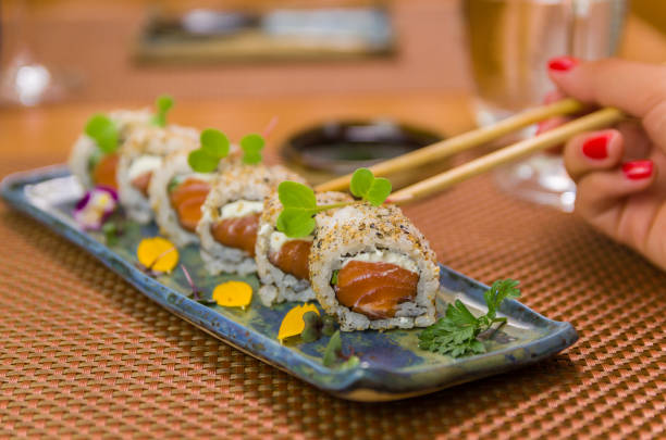 istock Woman eating delicious sushi 1386733813