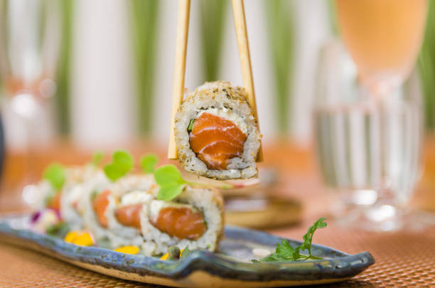 istock Woman eating delicious sushi 1386734353