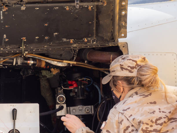 Zamora, Spain - March 20, 2022: Air Force female serviceman handling a fighter plane at a warplane exhibition. HD image.