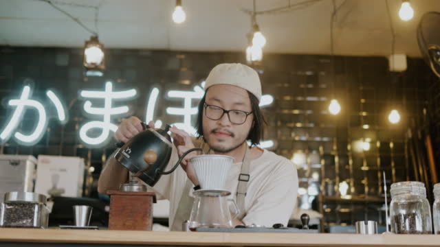 Barista brewed signature coffee of his cafe.