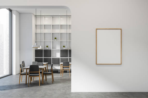 istock Bright cafe interior with empty white poster, tables with chairs 1386738063