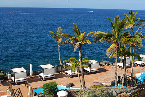 A coastal view of Los Gigantes, Tenerife with the Atlantic Ocean in the foreground.