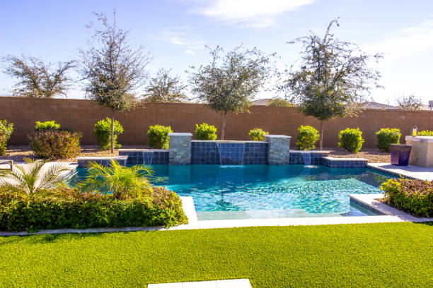 Swimming Pool With Waterfalls In Rear Yard