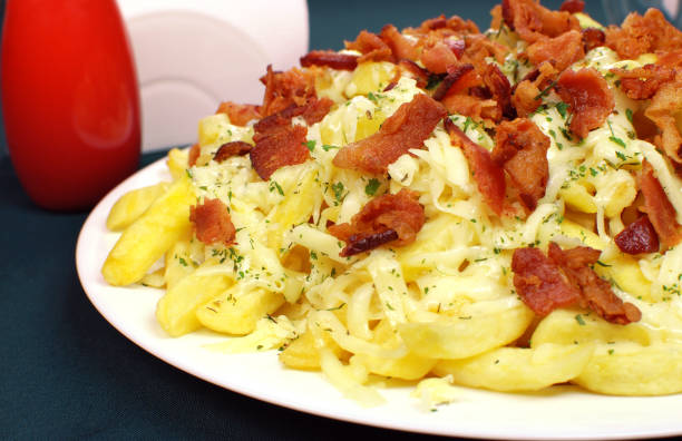 istock French fries with bacon and cheese close 1386740468