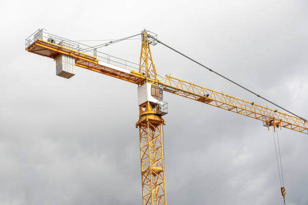istock Huge construction tower crane. Technology equipment for transportation for bring construction materials to over or high construction site. 1386742556