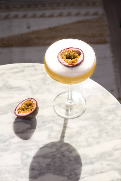 istock Passion Fruit cocktail aperitif in coupette glas with fresh fruit and foam 1386742576