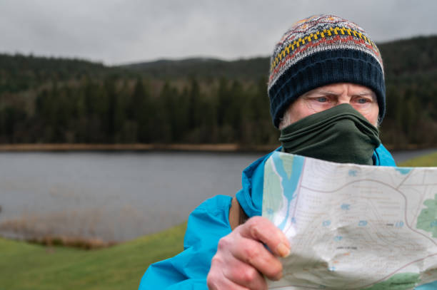 istock Close up of an active senior man checking his map 1386742815