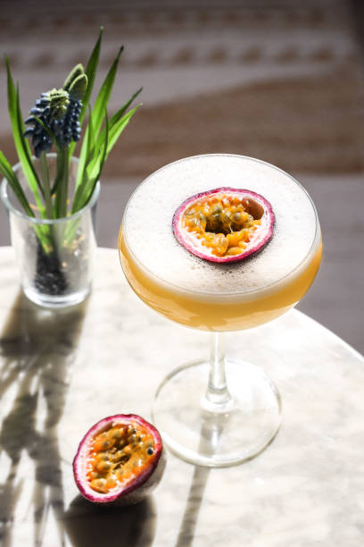 istock Passion Fruit cocktail aperitif in coupette glas with fresh fruit and foam 1386742880