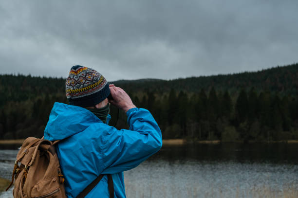 istock Retired man viewing a loch through binoculars 1386743635