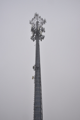 Just a cell tower in the cloud on a foggy spring evening