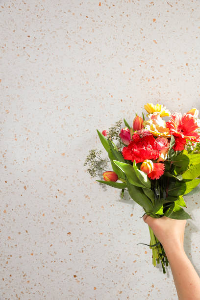 istock Hand holding tulip spring Bouquet in sunlight 1386753194