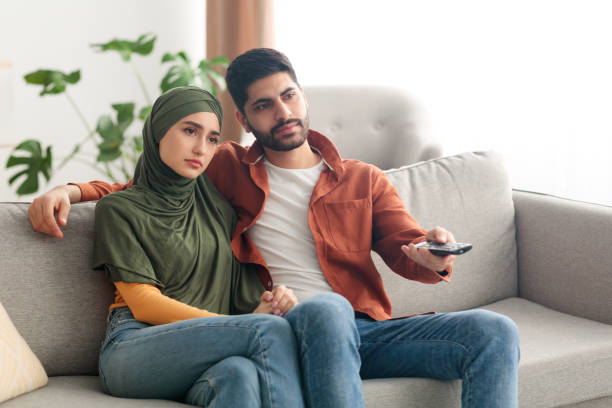 istock Discontented Middle Eastern Spouses Watching Television Sitting At Home 1386755021