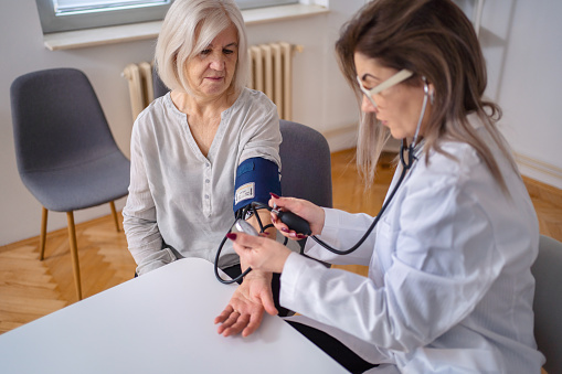 Mature adult woman has her blood pressure checked