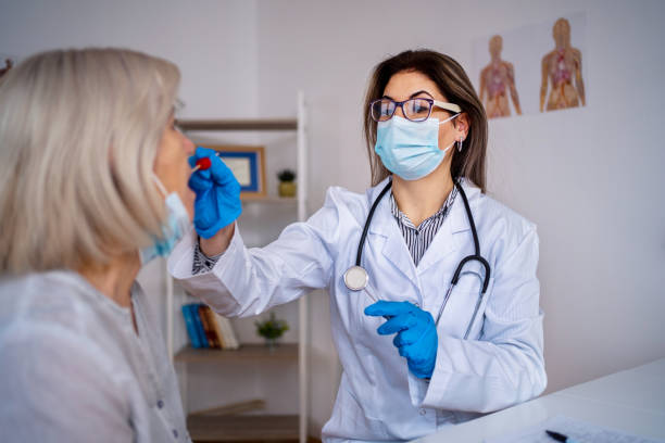 istock Doctor testing senior patient on possible coronavirus infection 1386755149