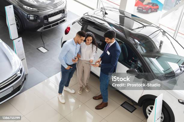 Customers Having Conversation With Sales Assistant Buying Car View Above Stock Photo - Download Image Now