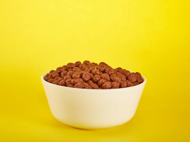 istock Chocolate Corn balls in bowl over yellow background 1386756469