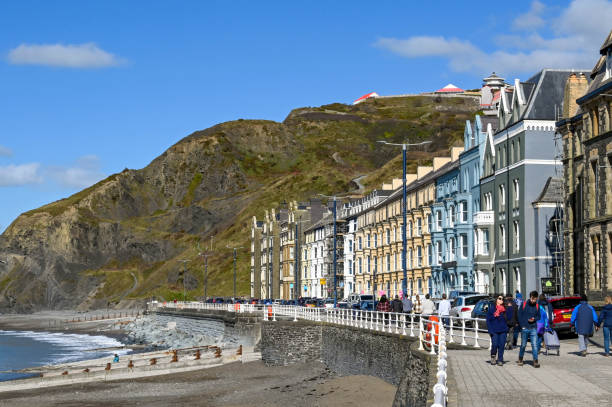 Flats on the seafront of Aberystwyth Aberystwyth, Wales - March 2022: Row of traditional terraced houses on the town's seafront. cardigan wales stock pictures, royalty-free photos & images