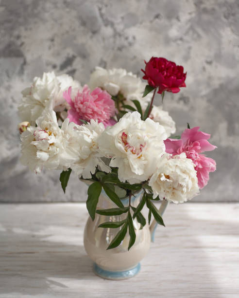 istock Still life with white and pink peonies in a white vase 1386757441