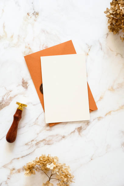 istock Stylish bronze wedding envelope, wedding invitation mockup, wax seal stamp, dried flowers on marble background. 1386759675