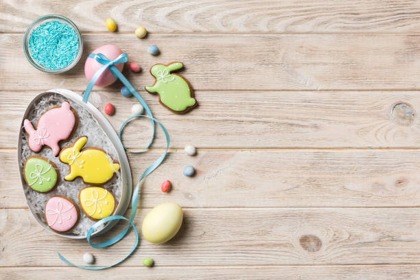 istock Colorful easter cookies in basket with Multi colors Easter eggs on colored background . Pastel color Easter eggs. holiday concept with copy space 1386759984