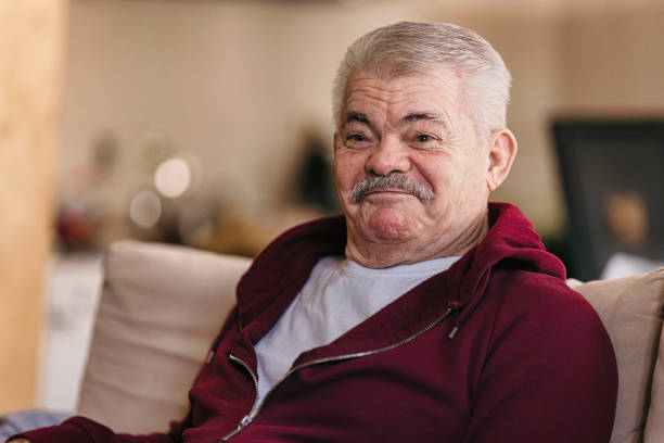 istock Aging Portrait senior man thinking  at home 1386762060