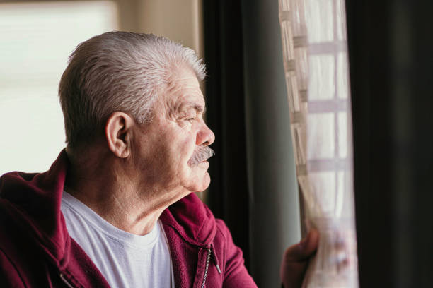istock Aging Portrait senior man thinking  at home 1386762084