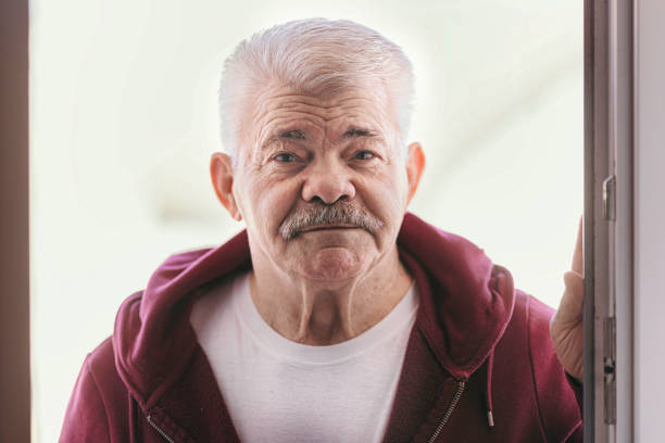 istock Aging Portrait senior man thinking  at home 1386762104