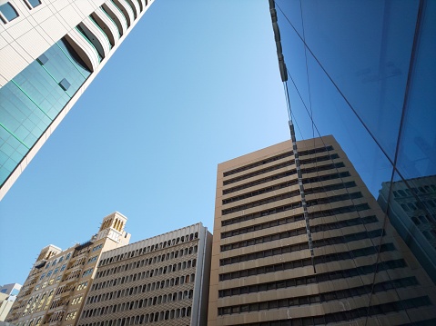 low angle view of modern buildings against clear blue sky