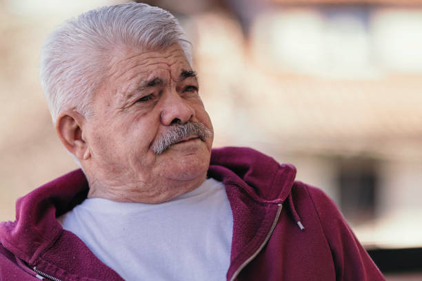 istock Aging Portrait senior man thinking  at home 1386762209