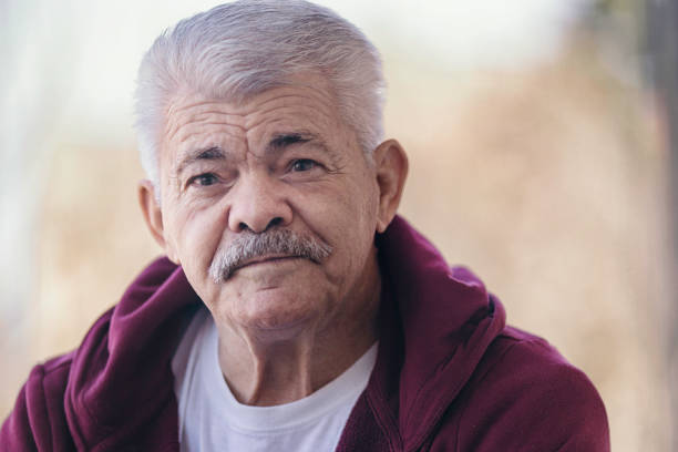 istock Aging Portrait senior man thinking  at home 1386762271