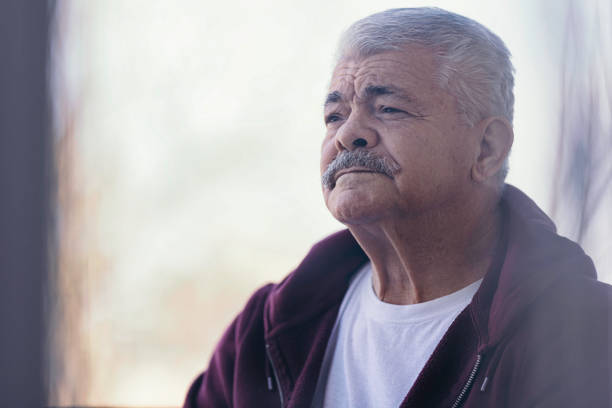istock Aging Portrait senior man thinking  at home 1386762276