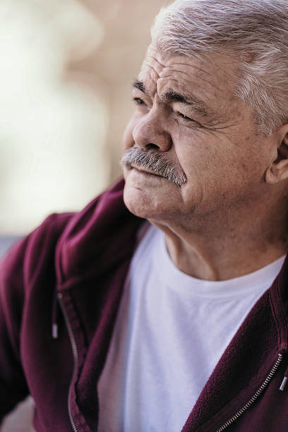 istock Aging Portrait senior man thinking  at home 1386762308