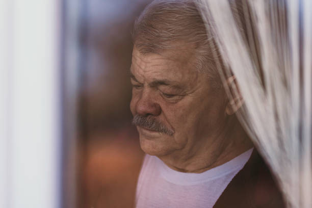 istock Aging Portrait senior man thinking  at home 1386762334