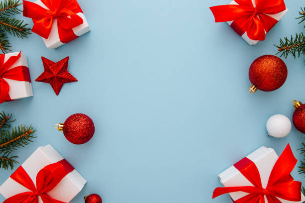 istock Christmas composition, gifts, fir tree branches, red decorations on blue background, winter, new year concept, flat lay, copy space 1386764204