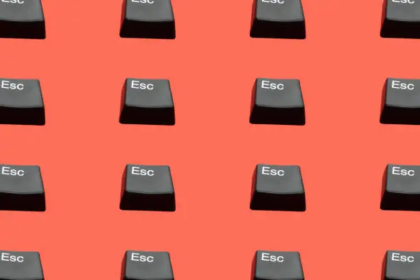 Photo of Creative seamless pattern of Esc buttons (escape keyboard key) on red background. Isometric view. Escape from dept, love, bad situation, relationship etc. Flat lay.