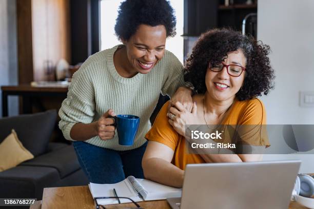 Cheerful Gay Couple Looking At The Laptop Stock Photo - Download Image Now - Gay Couple, LGBTQIA Rights, LGBTQIA People