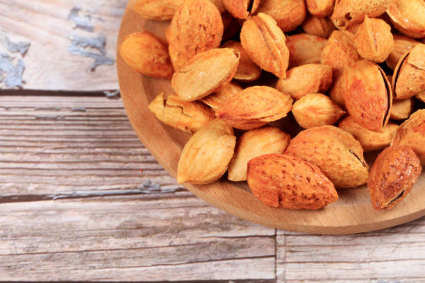 Badam, almonds is on the wooden table, close-up