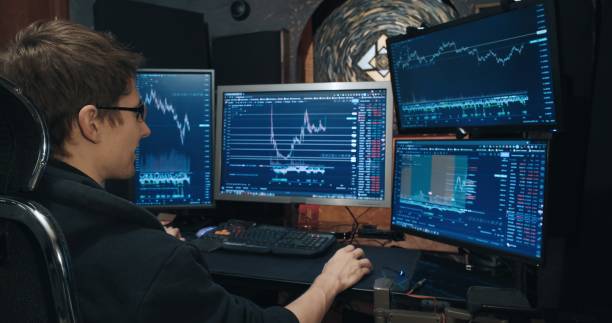 istock Man trader, freelancer on stock exchange trades options at home computer 1386776738