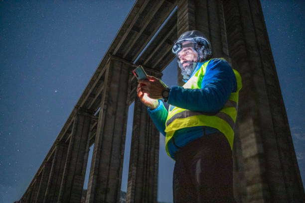 Road engineer working at night. Building new highways.