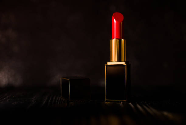 istock red lipstick in a dark gold case on a dark background 1386779903