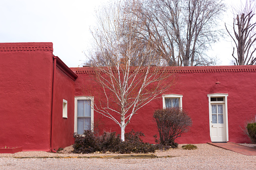 Santa Fe, NM: A traditional adobe house in Territorial style painted red in downtown Santa Fe.
