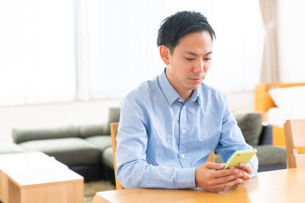 istock young man who uses smart phone 1386784055