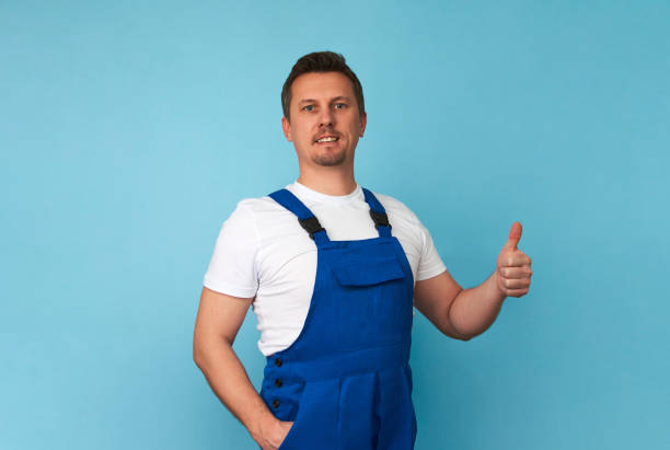 istock Delivery man with cardboard box on a blue background 1386784312