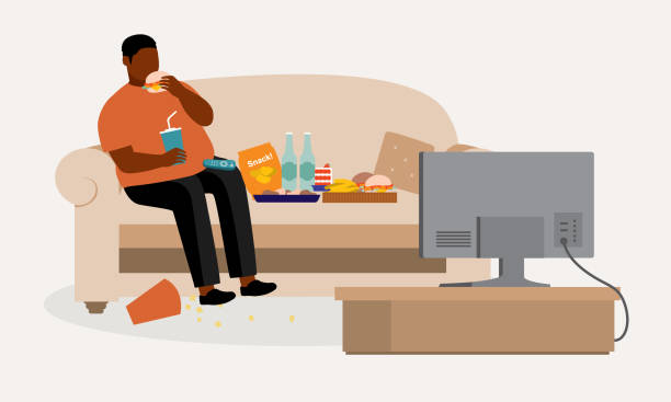 толстый черный мужчина ест нездоровую пищу во время просмотра телевизора. переедание. лентяй. - eating men fat overweight stock illustrations